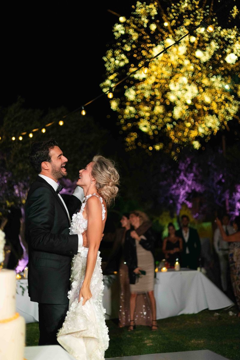 First dance under a canopy of golden bokeh lights — wedding photography by John Xenos, Greece.
